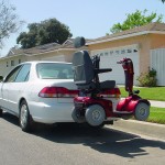 TRILIFT Classic on a class II Receiver Hitch, carrying a shoprider Scooter on a Honda Accord.